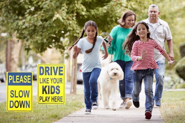 A picture of a family walking in an outdoor area with two traffic safety signs